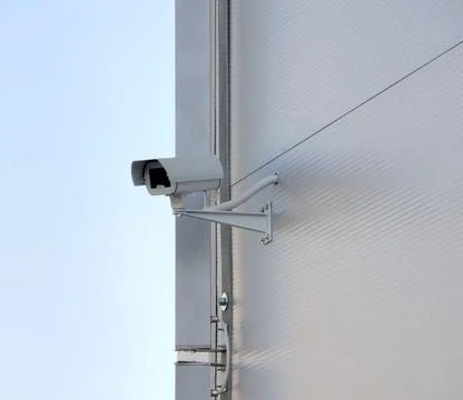 Security camera Surveillance security camera on facade. Big brother is wat... Stock Photos