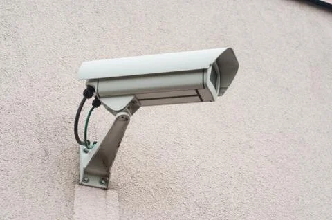 Security camera of surveillance on stoned wall Stock Photos