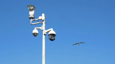 Security camera systems with multiple outdoor CCTV cameras on pole against .. Stock Footage 332745031
