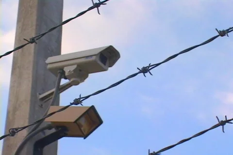 Security Camera Through Barbed Wire With Motion Sensor Video stock 141017