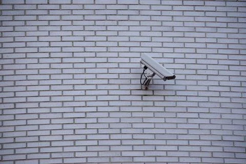 Security camera on the wall of the building Stock Photos