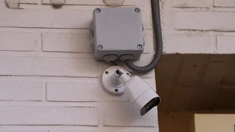 Security camera on wall with junction box surveillance system Stock Photos