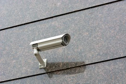Security camera on the wall. Stock Photos