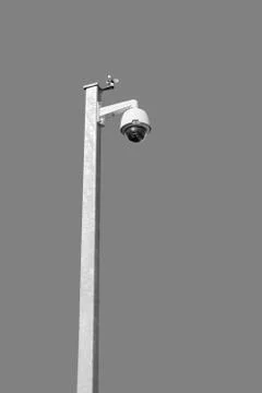 Security camera on white pole, isolated on grey background Stock Photos