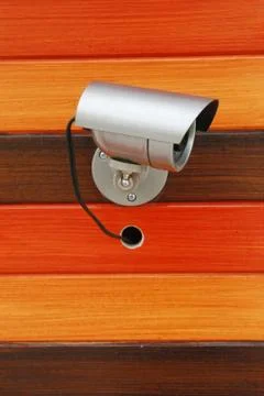 Security camera on wood wall Stock Photos