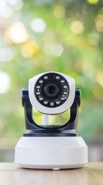 Security camera on a wooden table. Stock Photos