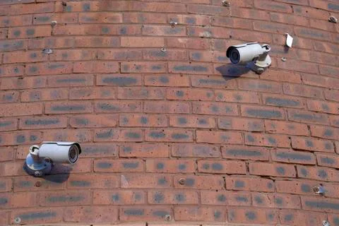 Security cameras in the brick wall Stock Photos