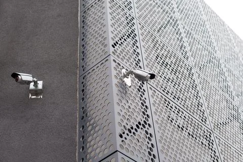 Security cameras on modern building. Professional surveillance camera. CCTV o Stock Photos