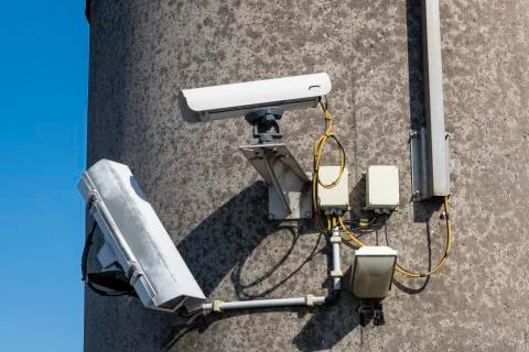 Security camera's outside with blue sky backdrop Stock Photos