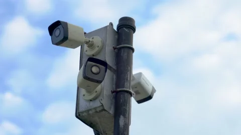 Security Cameras on a Pole with Clouds in the Background (pan shots) Stock Footage 238376063