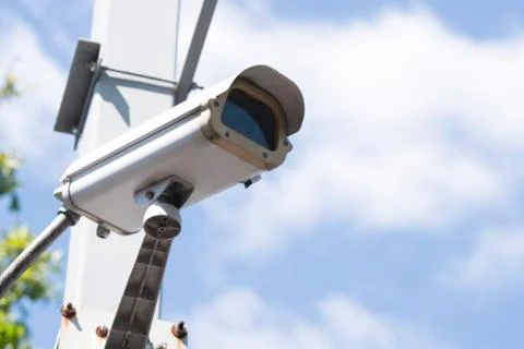 Security CCTV camera in garden , on blue sky background Foto stock