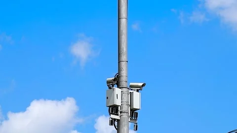 Security CCTV camera or surveillance system observes vehicular traffic on a.. Stock Footage 310045516