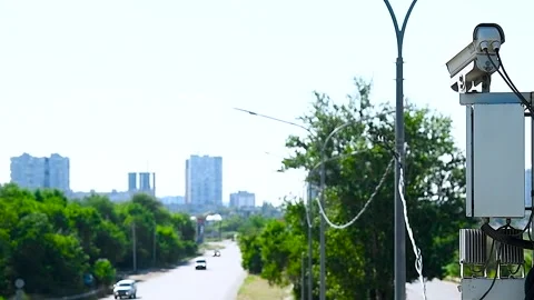 Security CCTV camera or surveillance system observes vehicular traffic on a.. Stock Footage 321612505