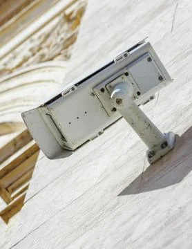 Security CCTV camera or surveillance system fixed on old construction wall Stock Photos