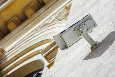 Security CCTV camera or surveillance system fixed on old construction wall Stock Photos
