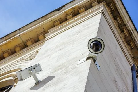 Security CCTV camera or surveillance system fixed on old construction wall Stock Photos