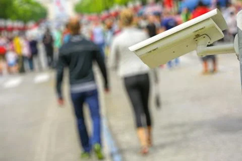 Security CCTV camera or surveillance system with lovers and the crowd on blur Stock Photos