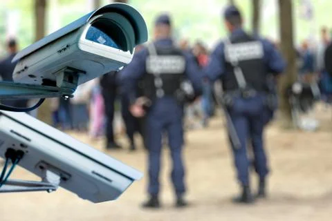 Security CCTV camera or surveillance system with military on blurry backgroun Stock Photos