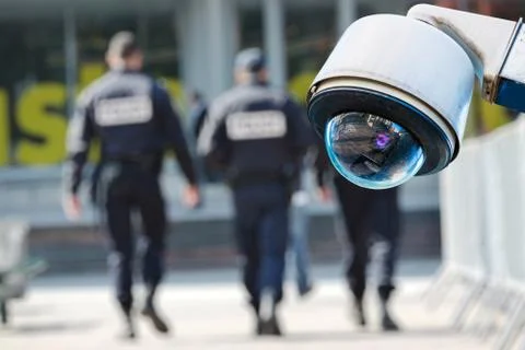 Security CCTV camera or surveillance system with military on blurry backgroun Stock Photos