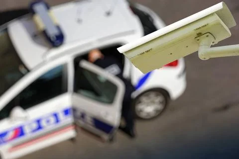 Security CCTV camera or surveillance system with police car on blurry back... Stock Photos