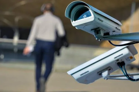 Security CCTV camera or surveillance system with man on blurry background ... Stock Photos