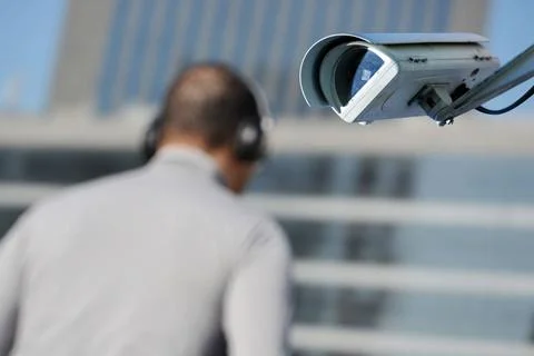 Security CCTV camera or surveillance system with man on blurry background ... Stock Photos