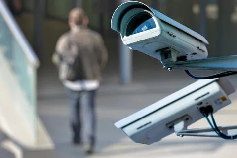 Security CCTV camera or surveillance system with man on blurry background ... Stock Photos