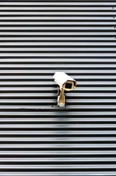 Security cctv camera on textured wall Stock Photos