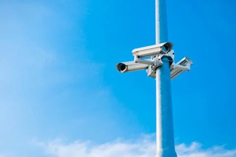 Security cctv cameras on blue sky Stock Photos