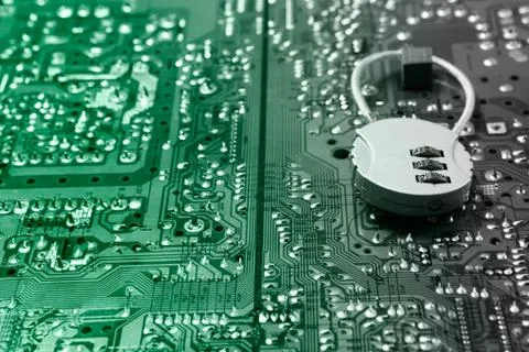 Security cipher padlock on computer circuit board. Stock Photos
