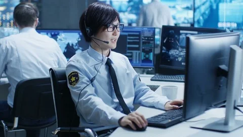 In the Security Command Center Officer at His Workstation Monitors Screens. Stock Footage 80988184