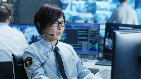 In the Security Command Center Officer at His Workstation Monitors Screens. Stock Footage 80990127