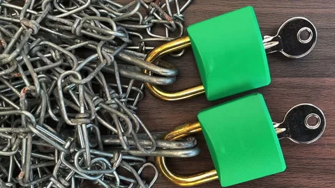Security concept. A chain falling around two green padlocks with keys. Video stock 274194498