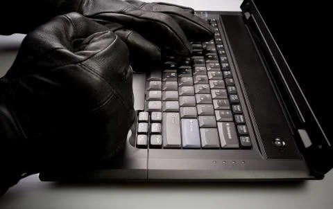 Security concept with mad hacker working on laptop at night Stock Photos