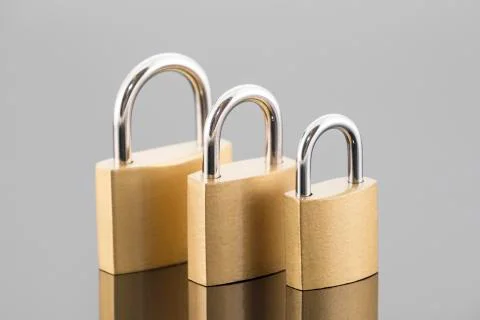 Security concept with three metal padlocks Stock Photos
