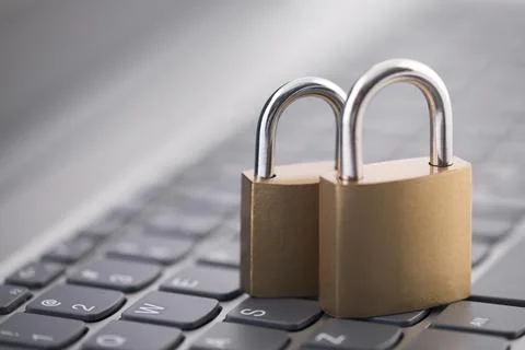 Security concept with two metal padlocks on computer keyboard Stock Photos