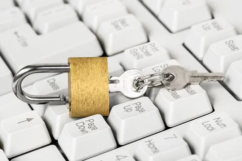 Security concept,open yellow padlock on white keyboard Foto stock