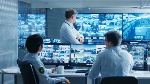 In the Security Control Room Chief Surveillance Officer Holds a Briefing. Stock Footage