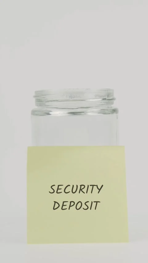Security deposit text or word on yellow sticky note attached to glass jar Stock Footage 311785239