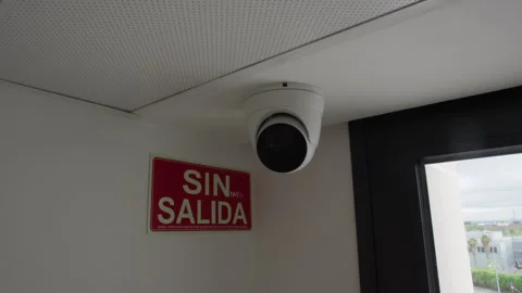 Security dome camera mounted on indoor ceiling corner Stock Footage 337785502