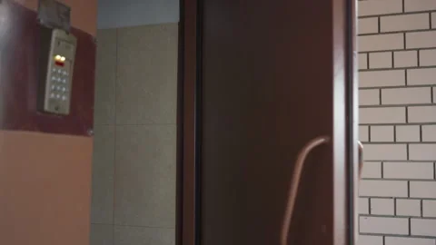 Security door with keypad slams while woman passes into office Stock Footage 321480206