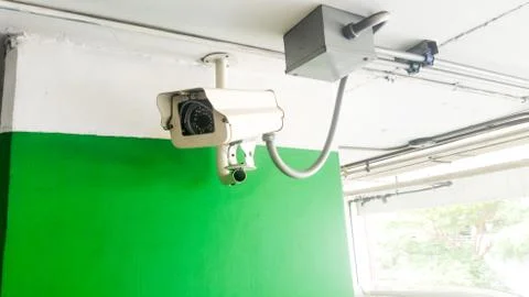 Security equipment concept. Closeup CCTV camera monitoring in the cars park. Stock Photos