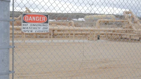 Security fence around explosive gas and oil lines Stock Footage 74312938