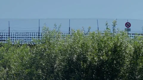 Security fence with barbed wire and drone warning sign at Daugavpils prison Stock Footage 340892557