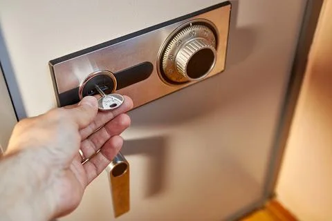 Security of finances and documents. Opening a coded safe. Stock Photos