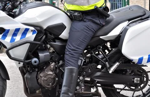 Security force blocking traffic on a public road with a motorbike Stock Photos