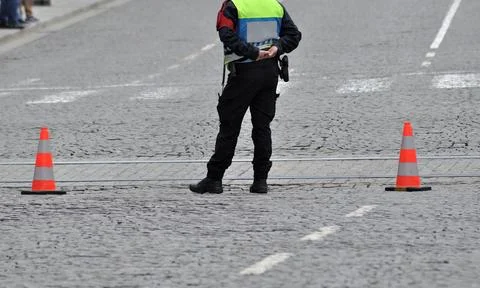 Security forces officer standing in the middle of a road Stock Photos