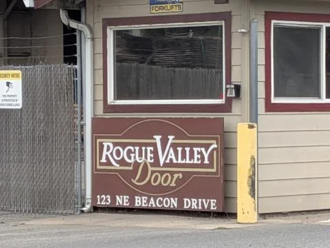 Security gate and building with “Rogue Valley Door” sign Photos