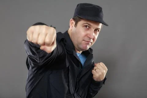 Security guard attack position isolated on gray background Stock Photos
