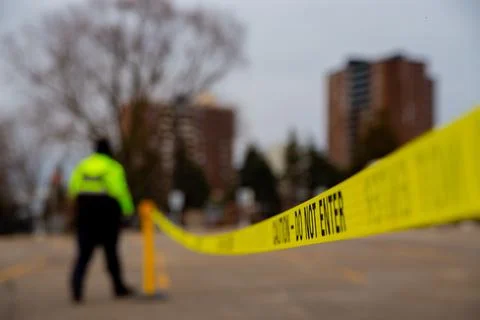 Security guard with caution tape to do parking enforcement at guest parking lot. Stock Photos